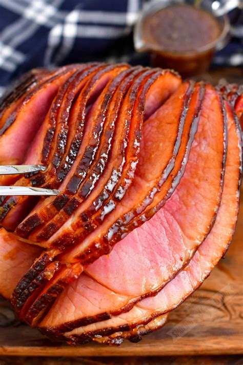 Preheat the oven to the recommended temperature. Place the ham in a roasting pan and cover it tightly with foil. Cook for 10-12 minutes per pound, until internal temperature reaches 140°F (60°C) Uncover the ham and baste it with glaze or pan juices for the final 15-20 minutes.